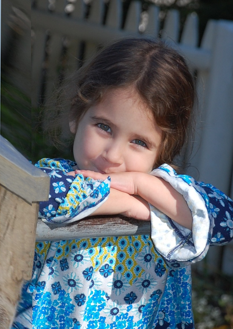 A Pine Grove child leaning on an outdoor railing.